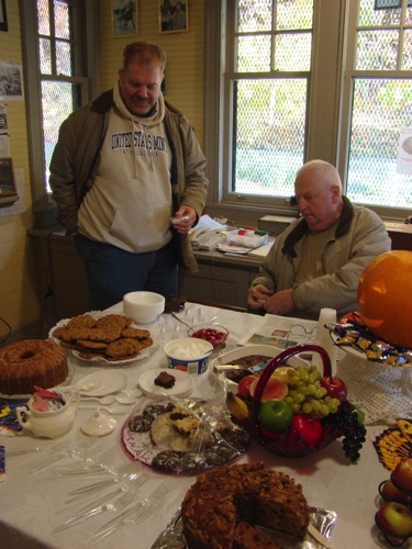 2010-10-30 Robert checking out refreshments as Fred 'supervises.' DSC07305.jpg